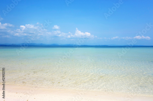 White clouds on blue sky over calm sea. Clear blue sky with fantastic white sand beach with calm ocean, Summer outdoor nature holiday serenity. Talu Island, Prachuap Khiri Khan, Thailand. © maemanee