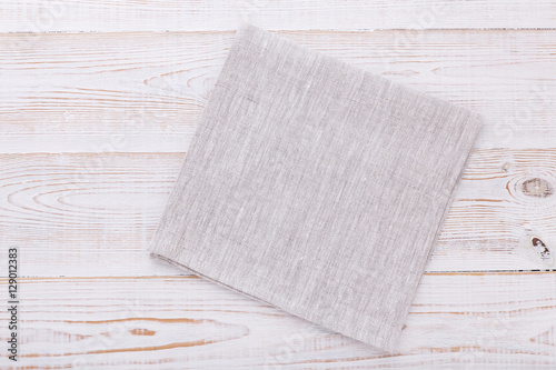 Napkin. Cloth napkin, tablecloth on white wooden background. Top view, mockup.