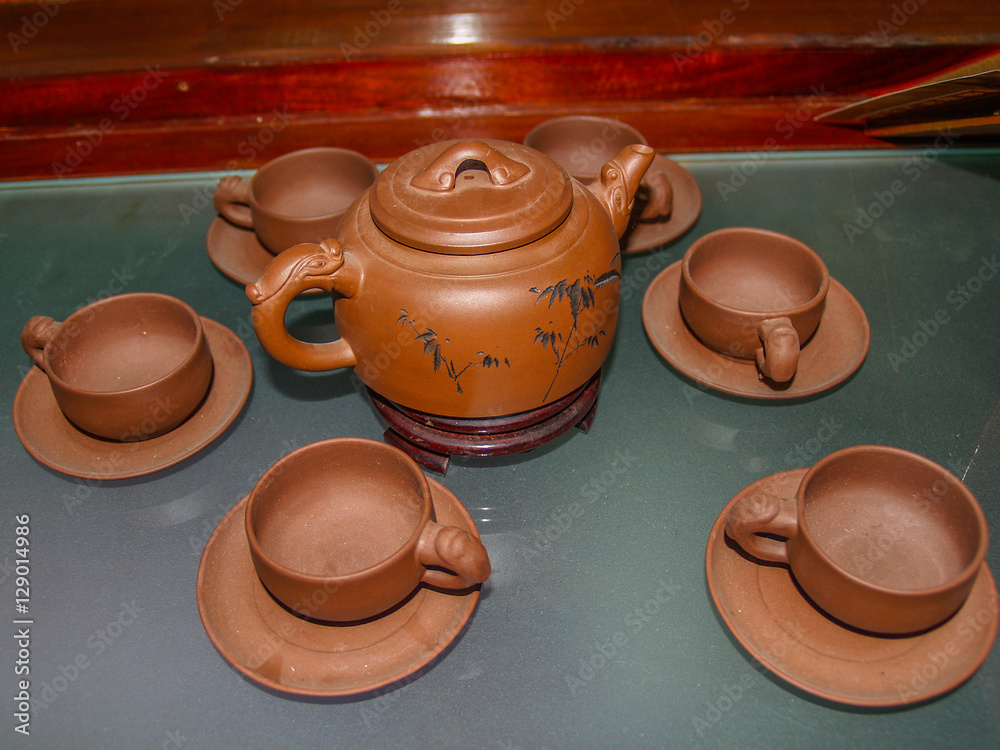 Chinese brown clay teapot with cups and saucer