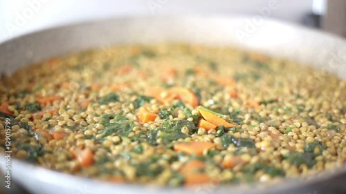 show cooking, lentils with spinach and red carrots prepared at home, italian recipe, healthy proteins food concept
