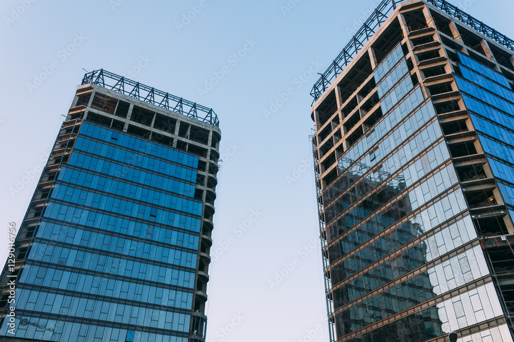 low angle of unfinished building on a background of blue sky at low angle of unfinished building on a background of blue sky at