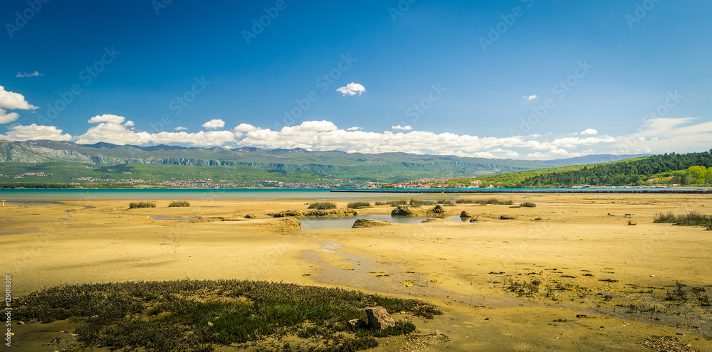 Clouds, mountains, sea and the beach panorama