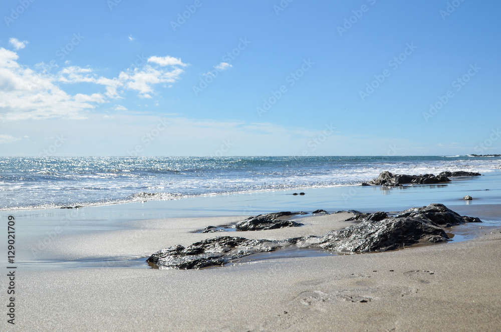 Glittering water at a sand beach Glittering water at a sand beach