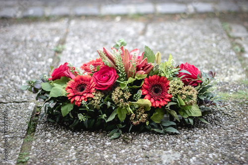 colorful flower arrangement wreath for funerals isolated on white