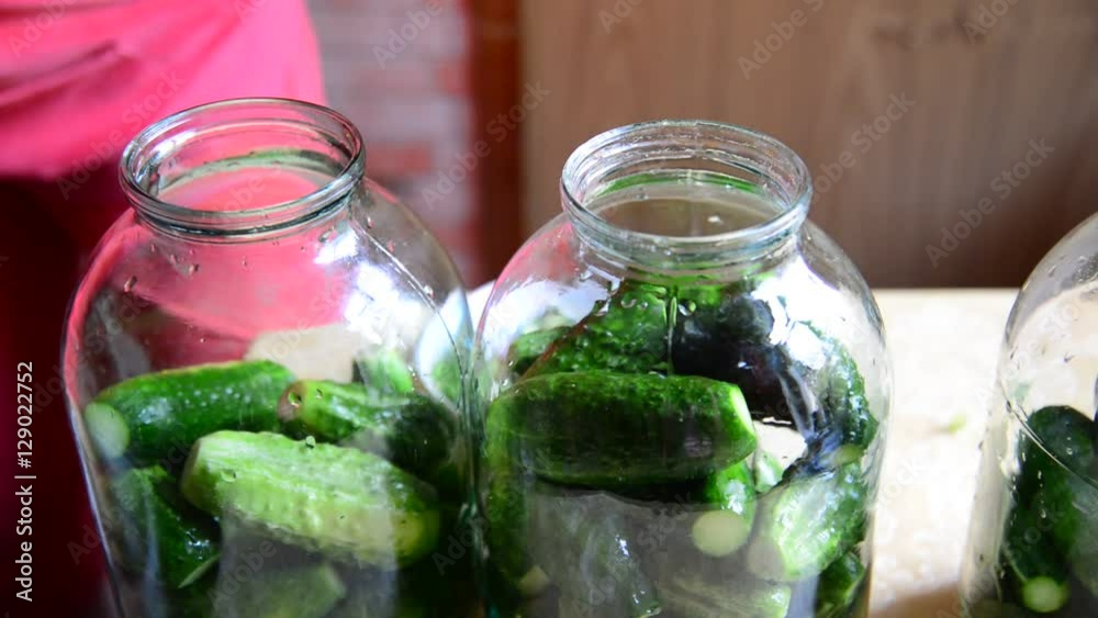 woman preparing homemade canned cucumbers for winter woman preparing homemade canned cucumbers for winter
