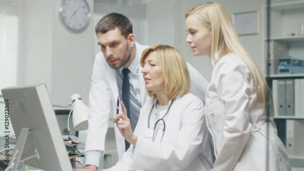 Medical Personnel Discuss Work Related Issues while Using Personal Computer. They Point at the Screen and Talk. Shot on RED Cinema Camera in 4K (UHD). Medical Personnel Discuss Work Related Issues while Using Personal Computer. They Point at the Screen and Talk. Shot on RED Cinema Camera in 4K (UHD).