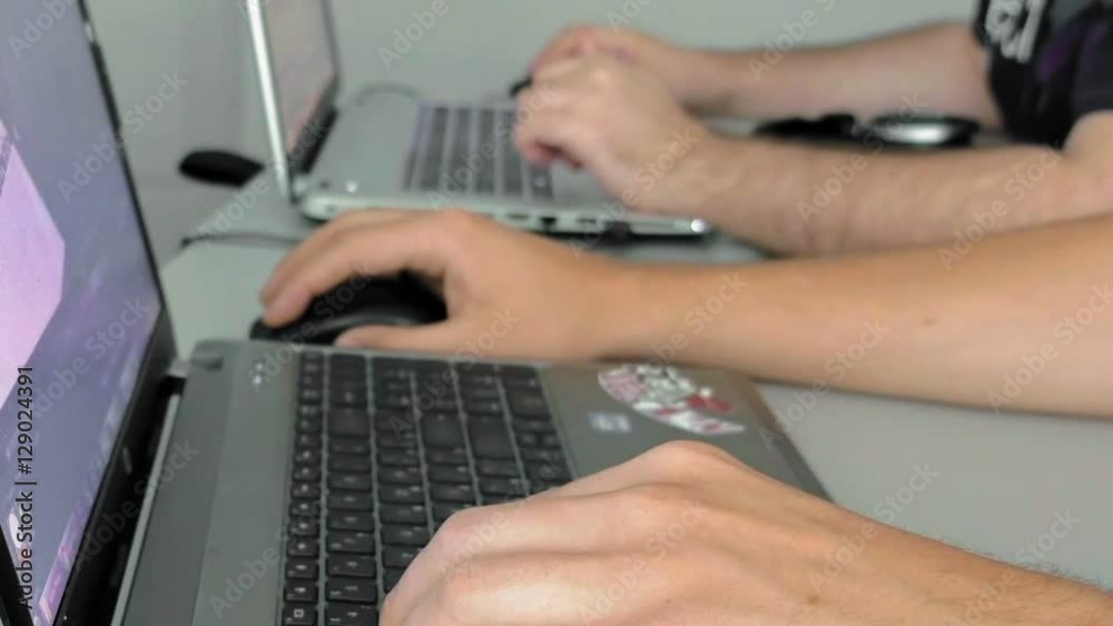 Both males are focused on their work. One of them is involved with graphic design. Teamwork is known to fasten the speed of the task. Both males are focused on their work. One of them is involved with graphic design. Teamwork is known to fasten the speed of the task.
