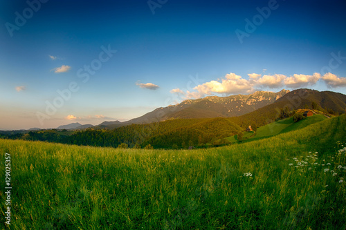 Evening  sunset on mountain hills of Simon village. Bran.