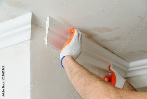 Installation of ceiling moldings.