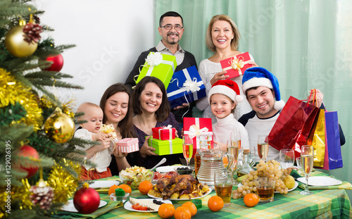 Mature parents with kids celebrating Merry Christmas