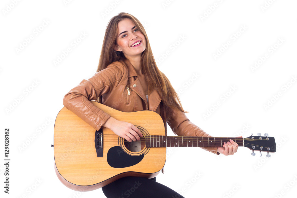 Young woman holding a guitar 