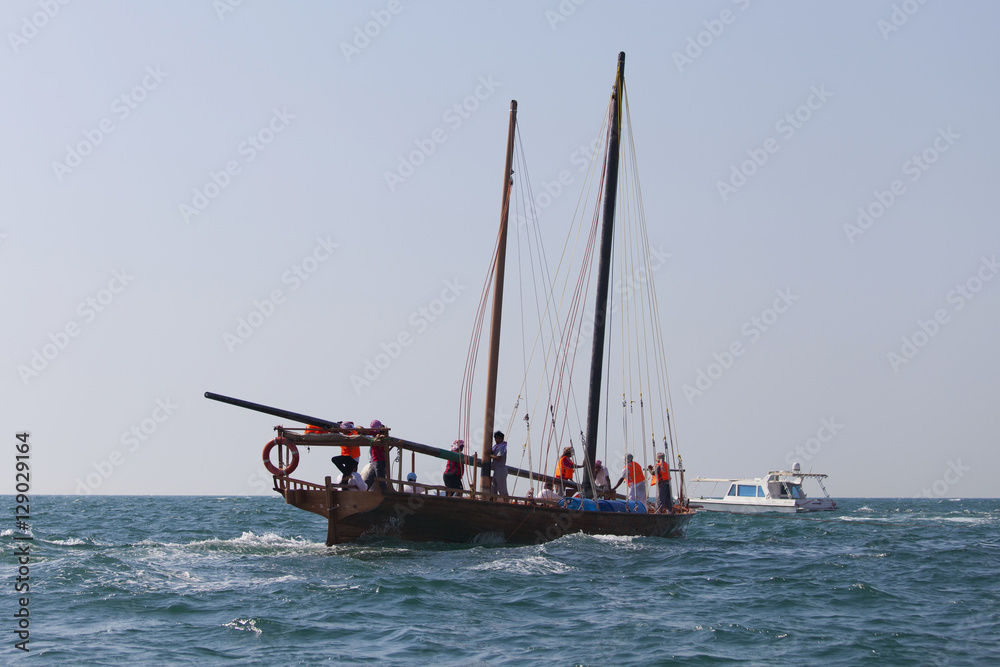 Racing traditional dhow in the Arabian Gulf, off Abu Dhabi Racing traditional dhow in the Arabian Gulf, off Abu Dhabi
