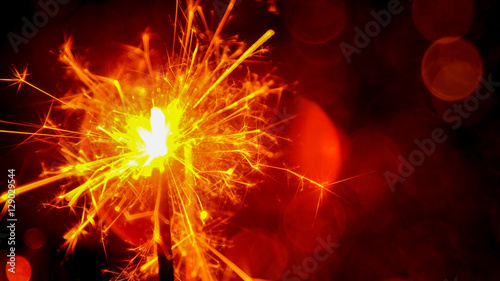 Christmas and New Year party sparkler with abstract circular bokeh background Christmas lights.