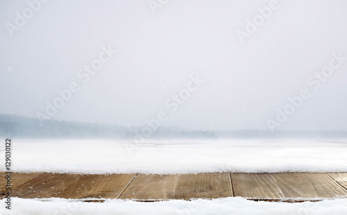 Wooden desk and winter decoration of snow with mountains landscape