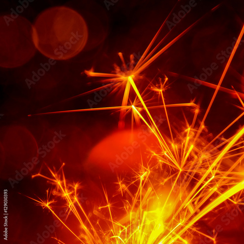 Christmas and New Year party sparkler with abstract circular bokeh background Christmas lights.