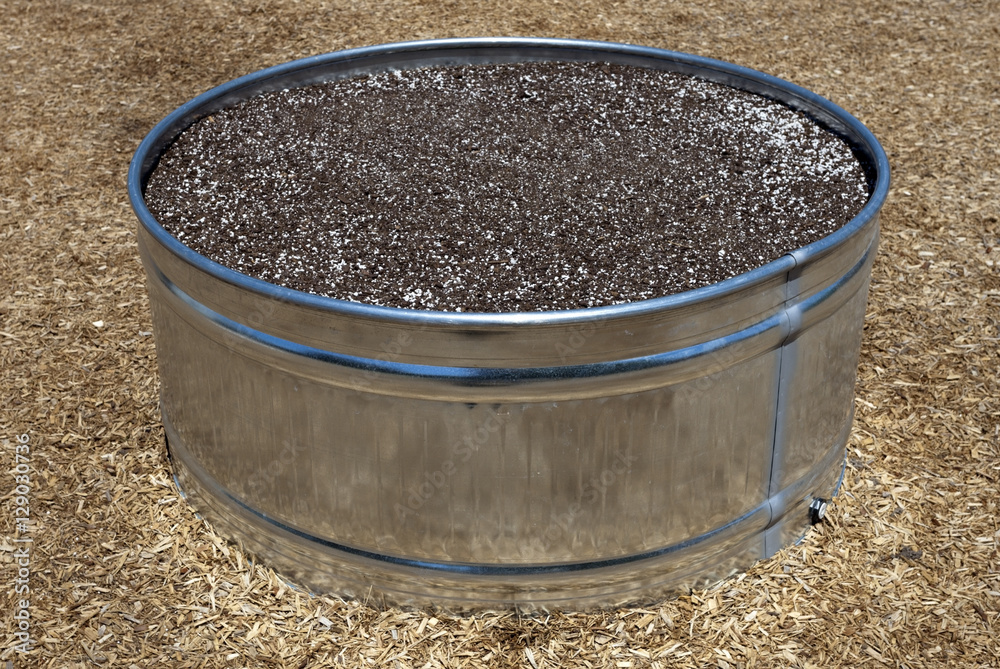 Stainless steel metal tub filled with potting soil. Stainless steel metal tub filled with potting soil.