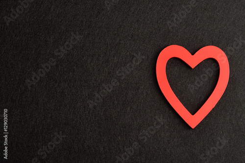 Valentine's Day. A red heart isolated against a black background