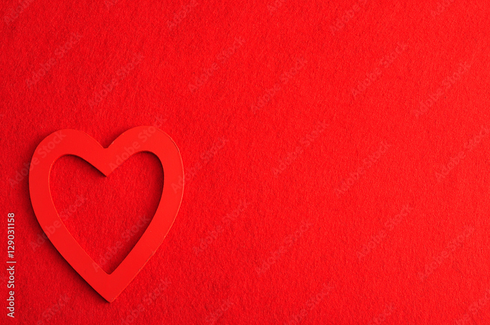 Valentine's Day. A red heart isolated against a red background