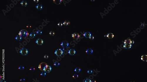 Colorful soap bubbles over black background

