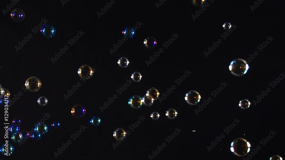 Colorful soap bubbles over black background
