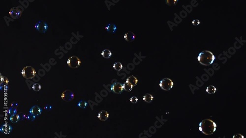 Colorful soap bubbles over black background

