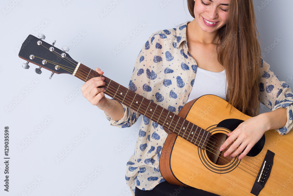 Fototapeta premium Young woman holding a guitar 