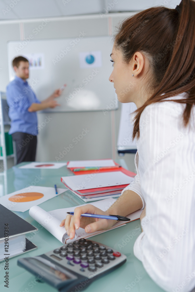 businesswoman with a calculator in a desktop at office
