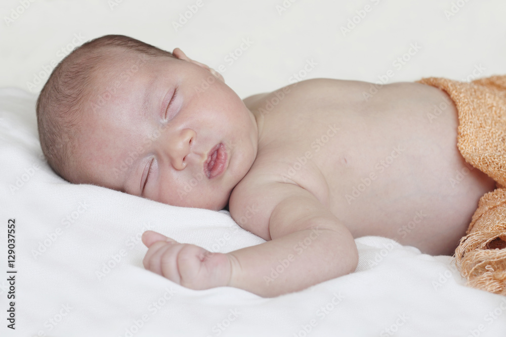 newborn sleeping in bed with orange blanket
newborn sleeping in bed with orange blanket