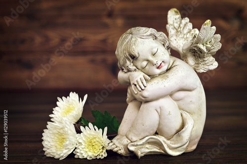 Angel figurine and white flowers © izzzy71