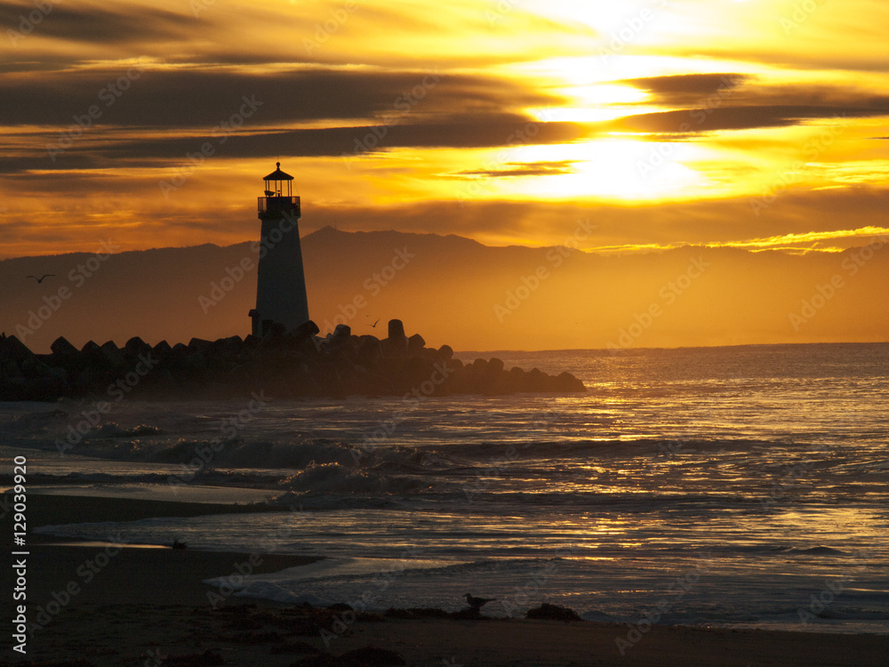 Lighthouse in an Electric Sunrise with Waves