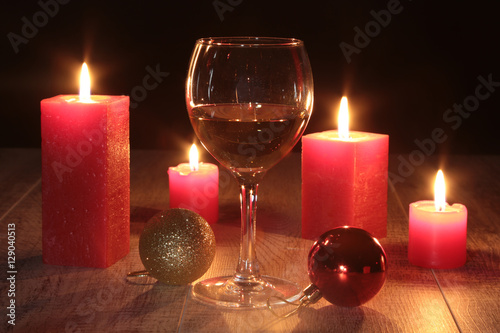 christmas composition photo cognac glass and candle on black background