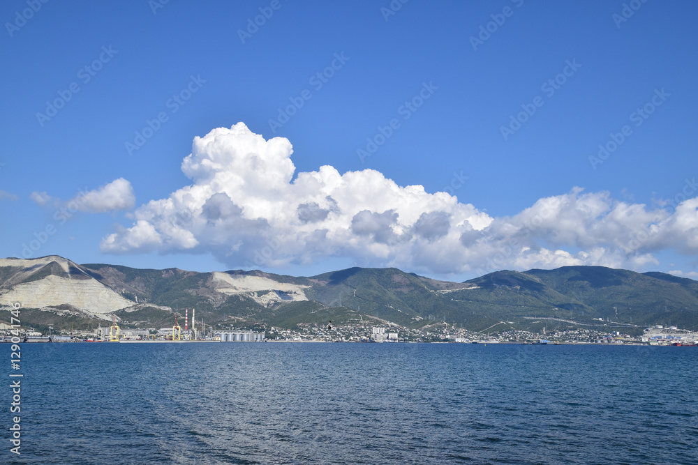 Sea bay landscape Tsemess. Mountains and clouds in the sky. In the distance can be seen the Marine cargo port