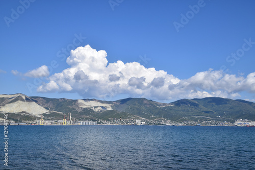 Sea bay landscape Tsemess. Mountains and clouds in the sky. In the distance can be seen the Marine cargo port