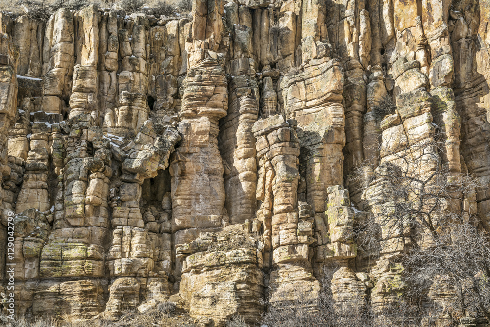 sandstone cliff with columns and pillars