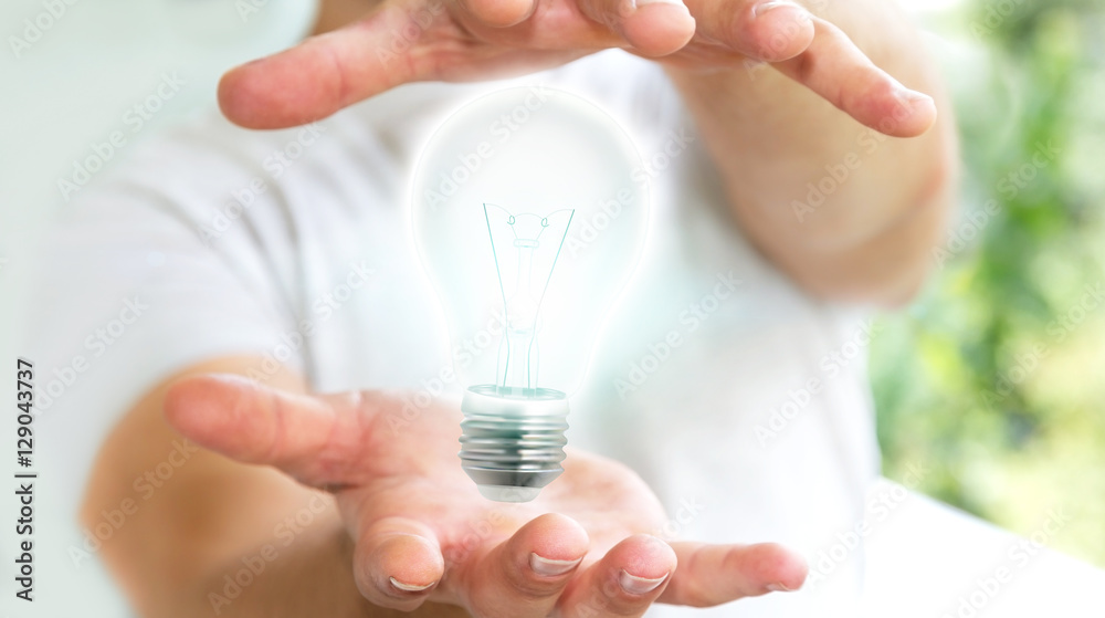 Businessman holding shiny lightbulb in his hand ‘3D rendering Businessman holding shiny lightbulb in his hand ‘3D rendering