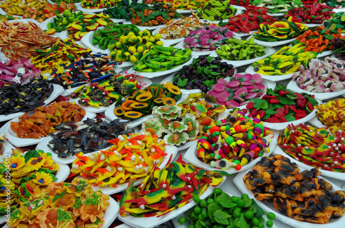 Mixed plastic food magnets displayed on white plates