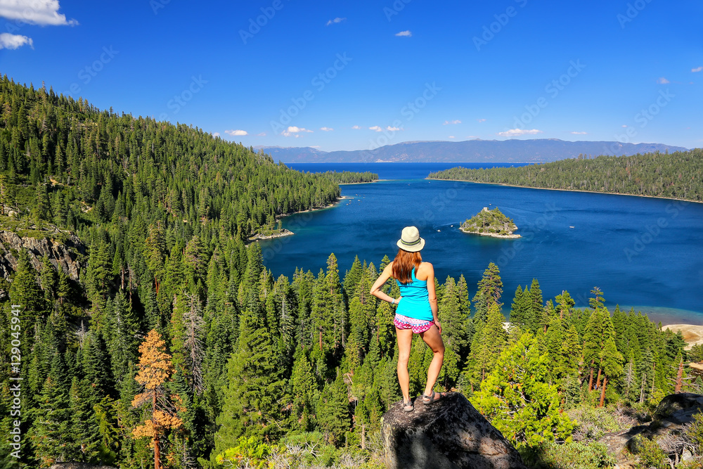 Fototapeta premium Young woman enjoying the view of Emerald Bay at Lake Tahoe, Cali