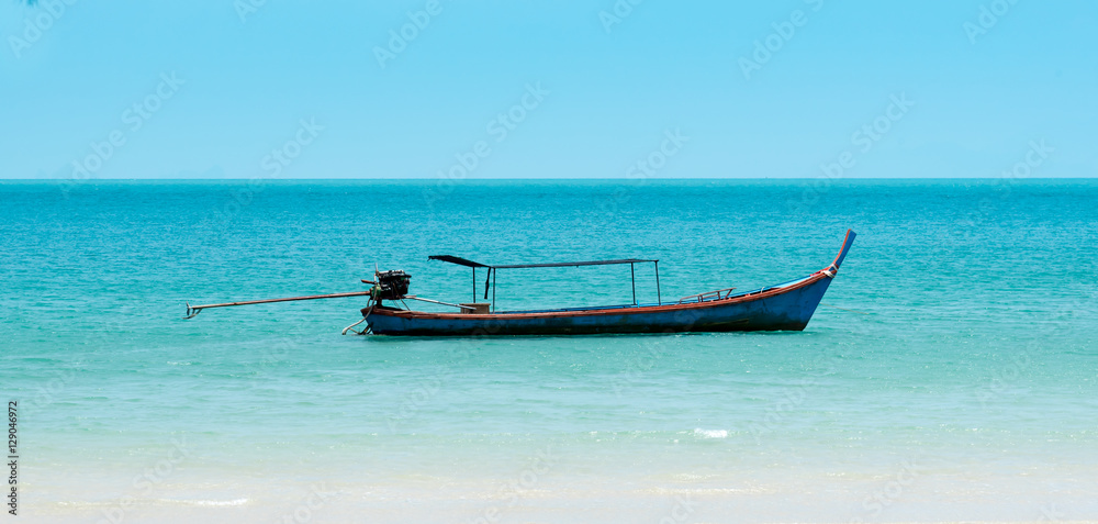 single fishing boat in blue sea
