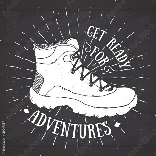 Vintage label, grunge textured Hand drawn retro badge or T-shirt typography design with hiking shoe, trekking boot vector illustration on chalkboard.