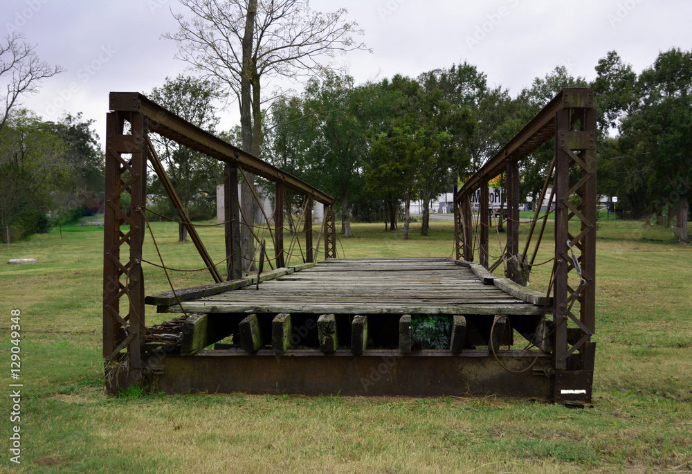 Bridge to nowhere/Old Steel and wood bridge sitting in grass Bridge to nowhere/Old Steel and wood bridge sitting in grass