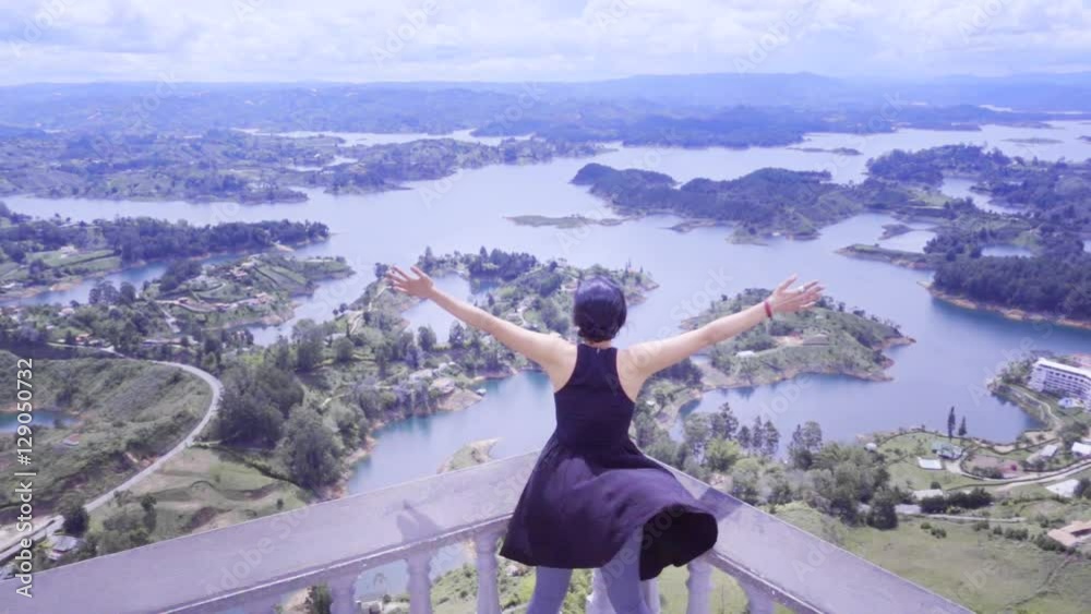 Hispanic woman in panoramic view of the islands of Guatape, Colombia. Slow motion Hispanic woman in panoramic view of the islands of Guatape, Colombia. Slow motion