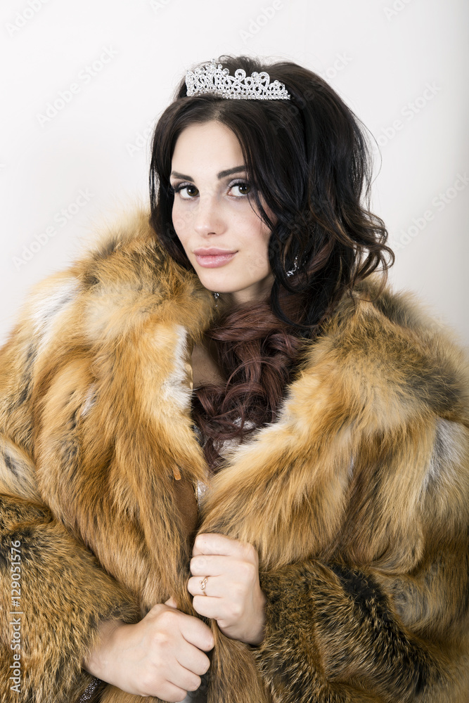 Beautiful young bride wearing white wedding dress and fur coat with professional make-up Beautiful young bride wearing white wedding dress and fur coat with professional make-up