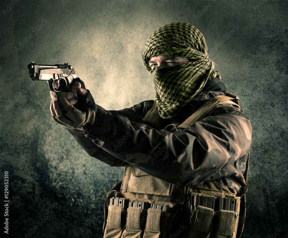 Portrait of a heavily armed masked soldier with grungy backgroun Portrait of a heavily armed masked soldier with grungy backgroun