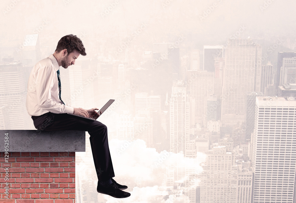 Office worker sitting on rooftop in city Office worker sitting on rooftop in city