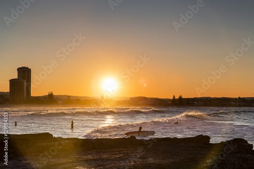 Summer beach vibes and long boarding, as the sun's rays hit the shore at Currumbin Rock Gold Coast