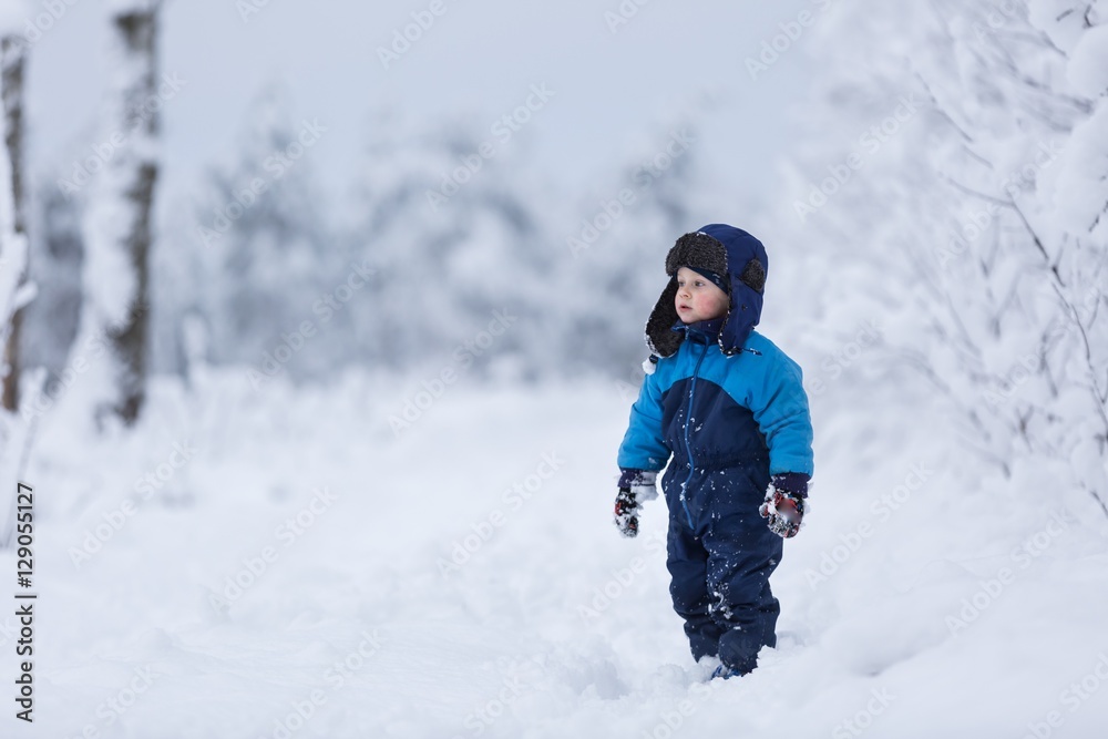 Happy caucasian child playing in snow