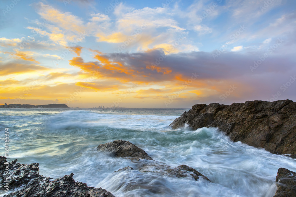Currumbin Rock Gold Coast, stormy sunset with ocean tide rushing over the rocks.