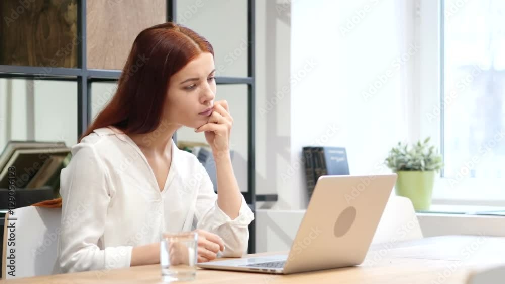 Woman Reading on Laptop in Office