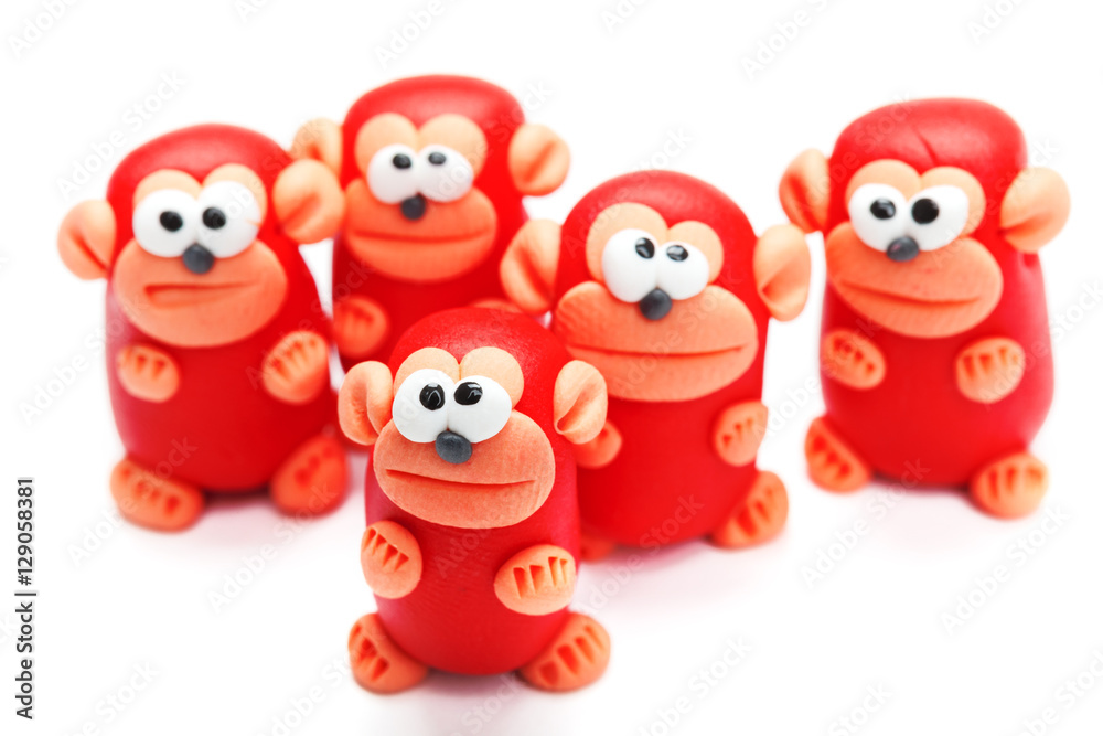Naklejka premium Group of clay toys (monkeys). Isolated on white background