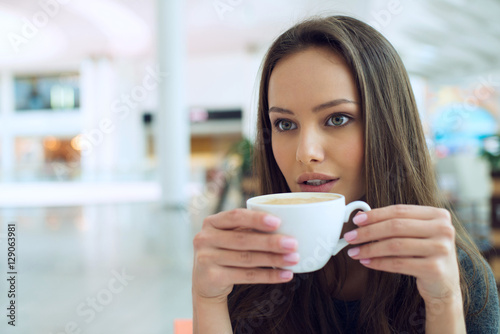 woman drinking coffee in the morning at restaurant soft focus.